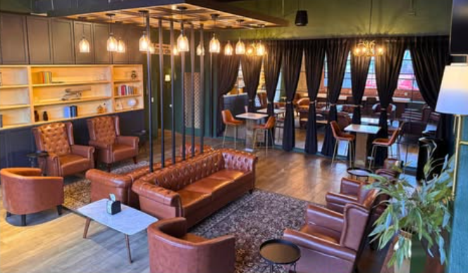 Modern coworking lounge space with leather seating and ambient lighting at Vanderwork